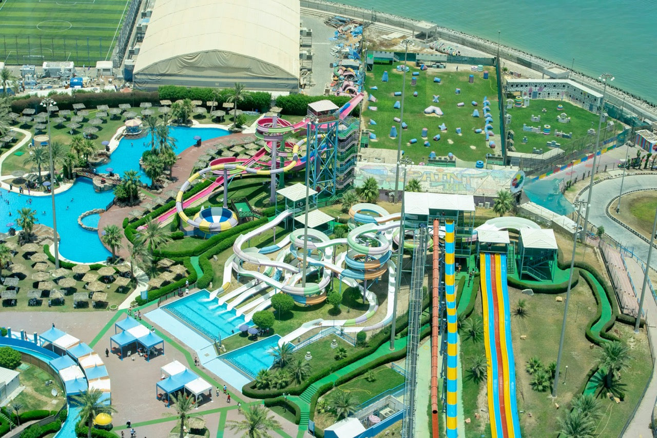 Aerial view of a vibrant waterpark showcasing various water slides, pools, and recreational areas, highlighting the role of solenoid valves like ODE and UNID in regulating water flow for a safe and enjoyable experience.